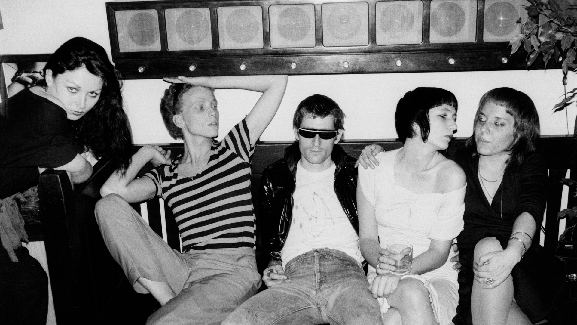 Image. A black and white image of youthful and stylish festival attendees.